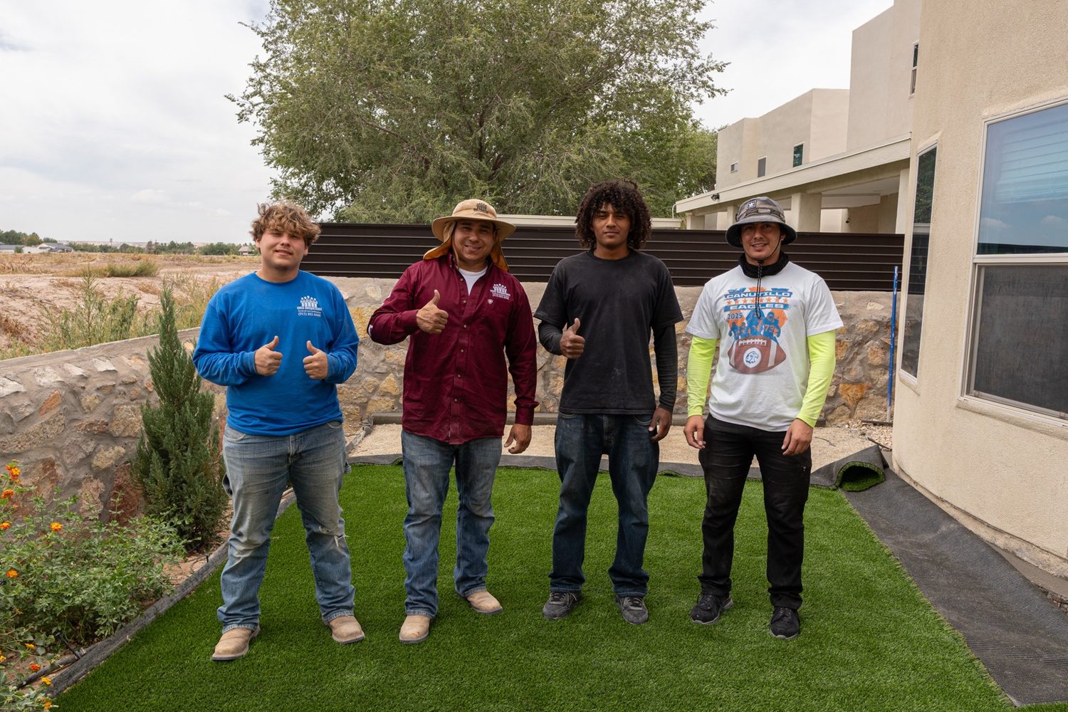 Cinco Mosqueteros crew standing on a finished turf install